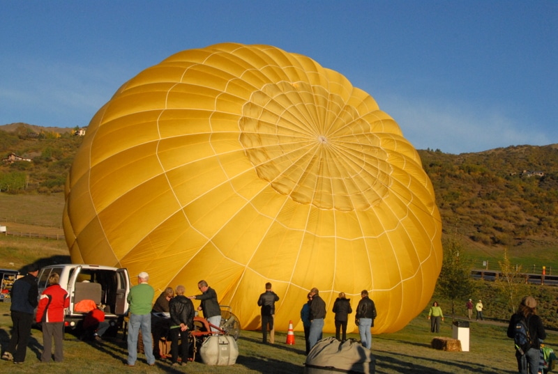 Inflating a yellow hot air balloon