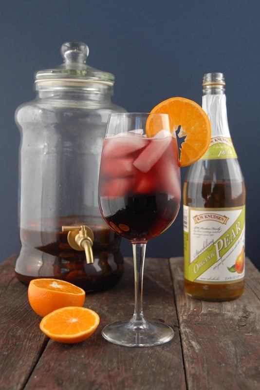 glass of autumn sangria with pitcher in background