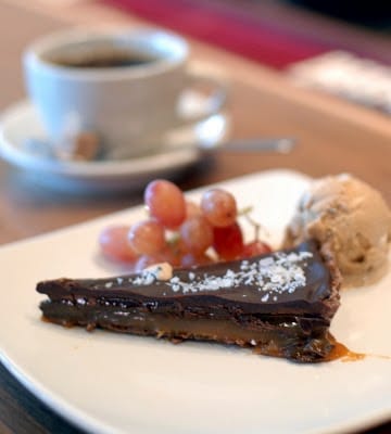 A piece of chocolate cake on a plate, with Tart