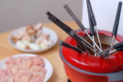 A bowl of food on a table, with Fondue and Hot pot