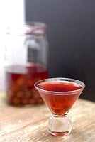 homemade cherry bounce in a glass and jar