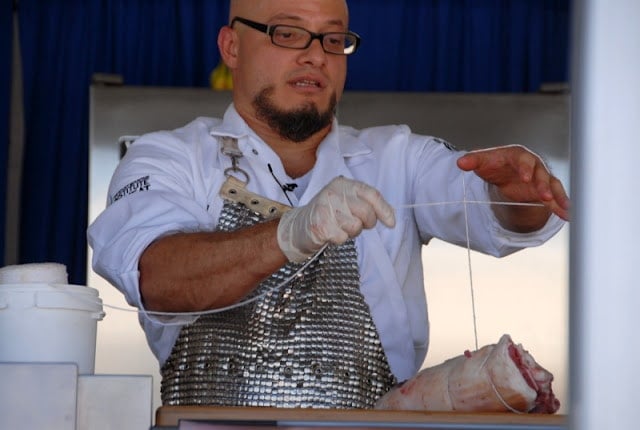 chef trussing meat with string