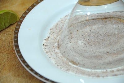 A plate with sugar rimming a cocktail glass