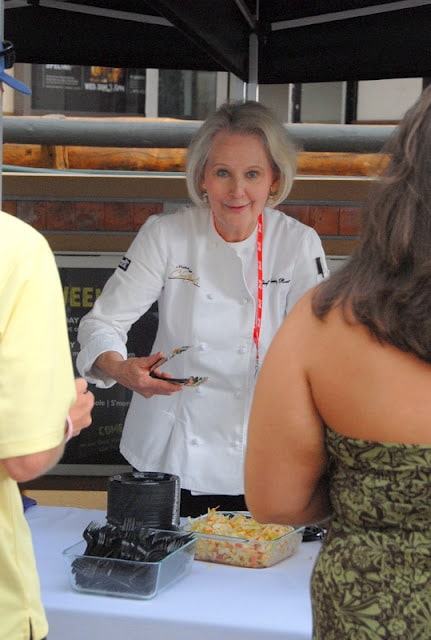 Christy Rost preparing food in a restaurant at Snowmass Culinary festival