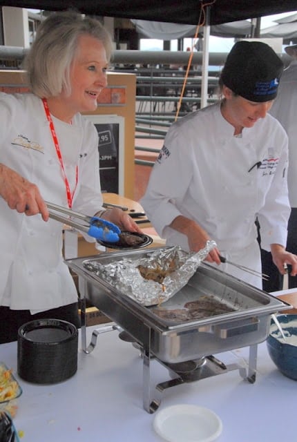 A group of people preparing food in a kitchen, with Chef and Cook