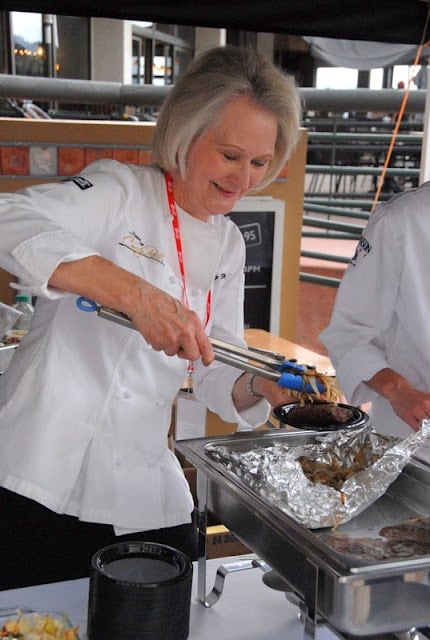 Christy Rost cooking in a kitchen preparing food