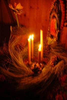 A blurry image of  lit candles