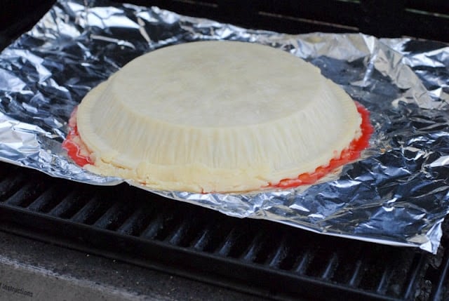 cherry tart on top of a pan on a grill, 