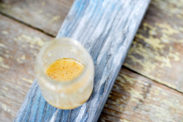 jar of salad dressing on distressed wood