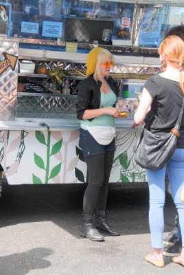 A person standing in front of a food truck