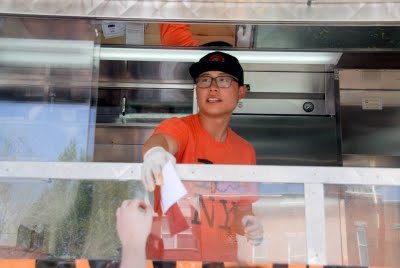 guy working in food truck for Food Networks\' Great Food truck race Denver