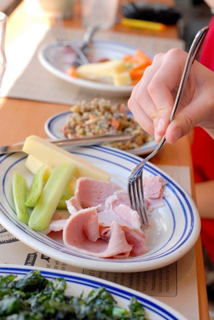 A person sitting at a table with a plate of food