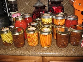 A counter topped with lots of canned and pickled food