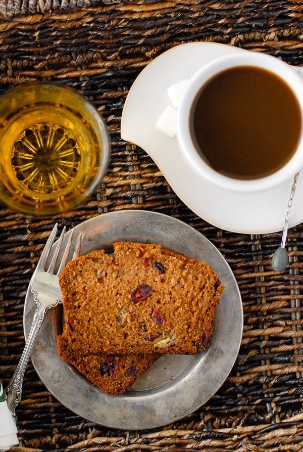 slice of Pumpkin Roasted-Banana Quick Bread on silver plate with coffee