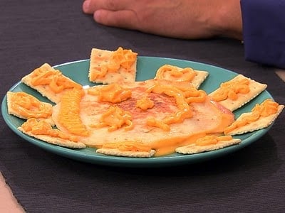 A person sitting at a table with a plate of food