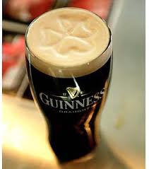 pint of Guinness beer with shamrock on foam