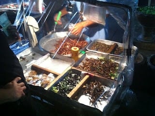 A person that is cooking some food, with Street food