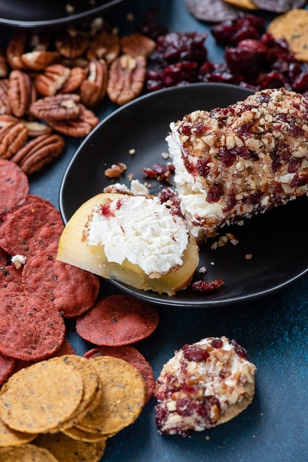 Cranberry Pecan Goat Cheese Appetizer roll sliced on apple slice