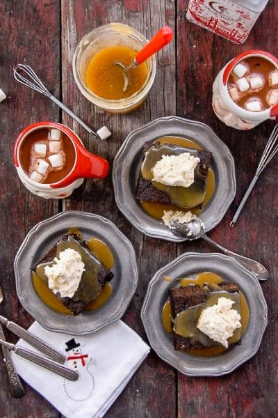 plates of gingerbread cake with butter rum toffee sauce and whipped cream