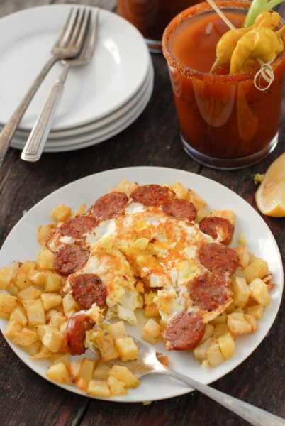 A close up of a plate of food on a table, with Bloody Mary