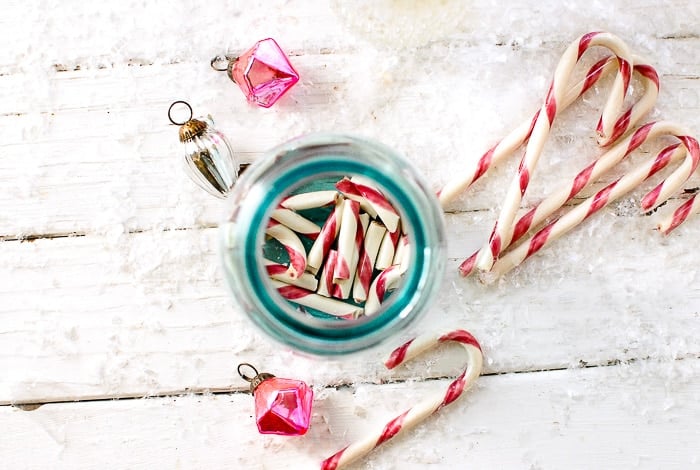 pink candy canes in blue Mason jar infusing with vodka