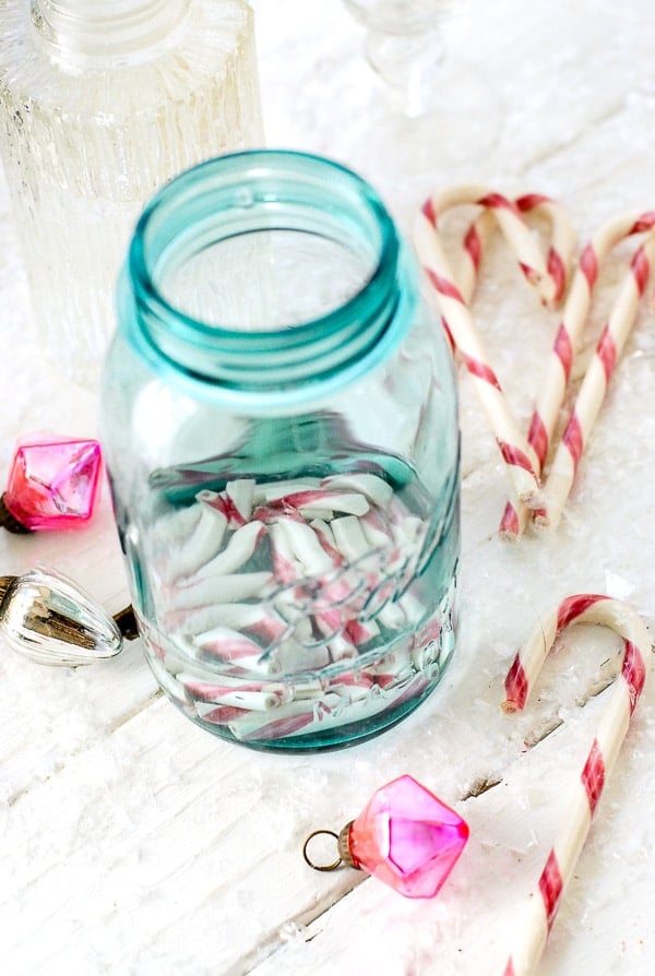 vodka and candy canes in Mason jar