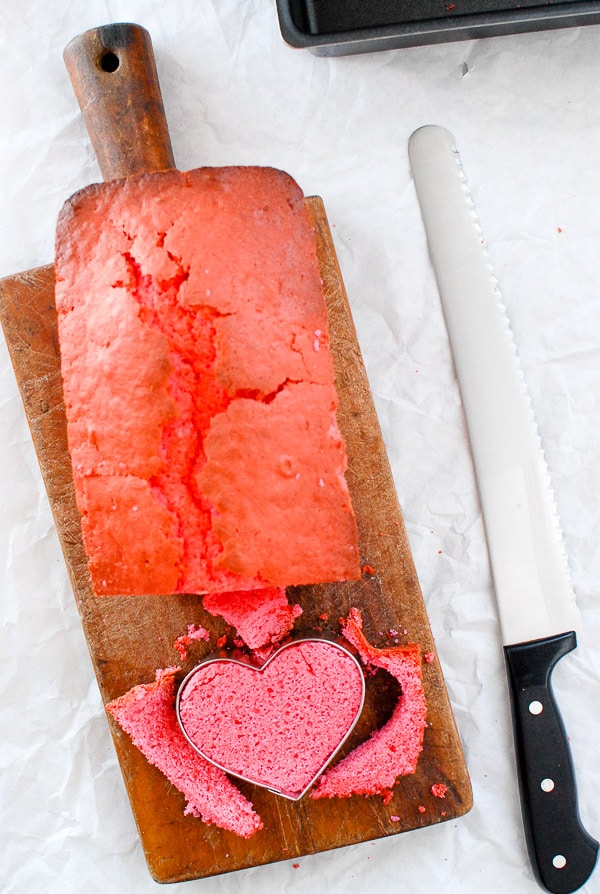 pink pound cake cutting hearts with cookie cutter