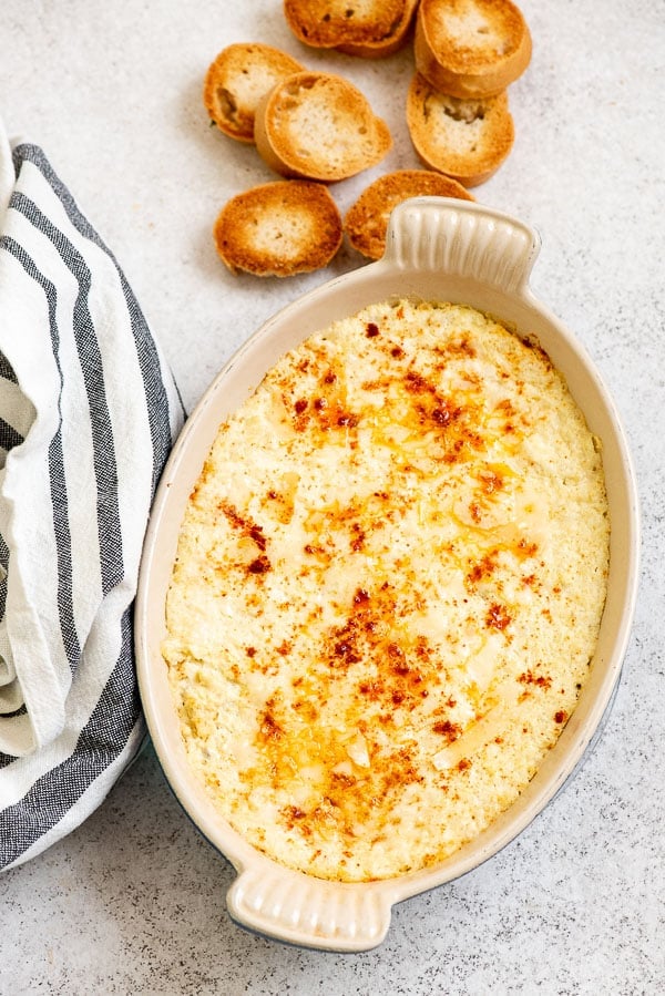 Creamy Hot Artichoke Dip with garlic toast rounds