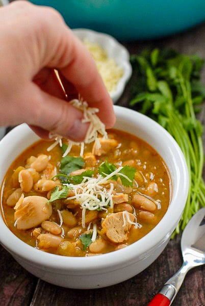 adding grated cheese to white chicken chili