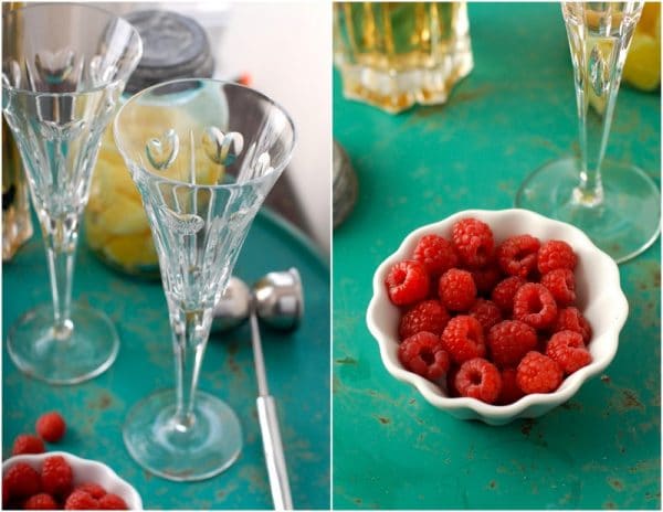 Glass goblet and bowl of raspberries