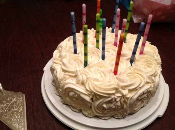 white birthday cake with striped candles