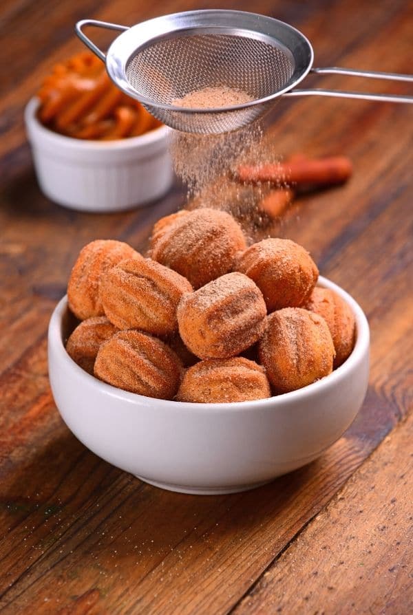 churro bites in a bowl with cinnamon sugar