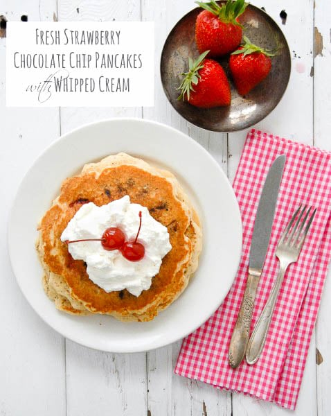 Fresh Strawberry Chocolate Chip Pancakes with Whipped Cream and maraschino cherries - titled photo