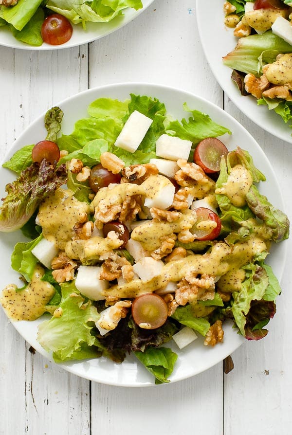 Red Grape Walnut Salad with Mango-Jalapeno Poppy Seed Dressing on white plates 