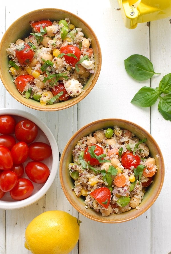 bowls of Rainbow Quinoa Summer Salad and bowl cherry tomatoes
