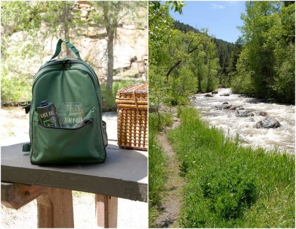 picnic table with backpack and river