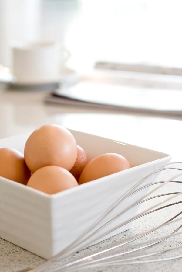 eggs in a white bowl with whisk