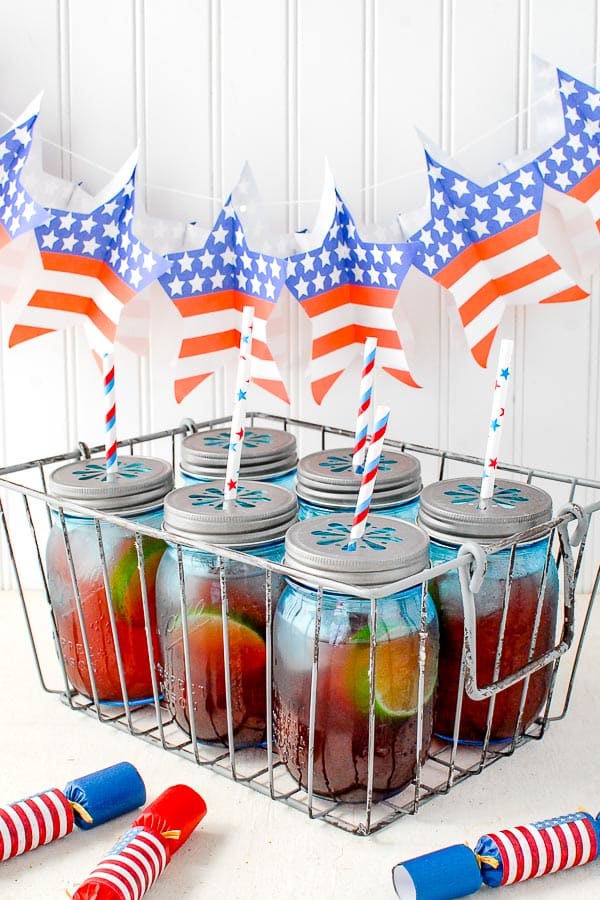 Six blue jars filled with Firecracker Punch recipe for Fourth of July