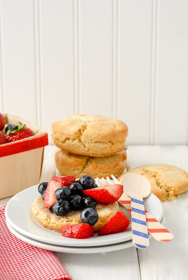 Shortcake biscuits with sweetened strawberries and blueberries on plate