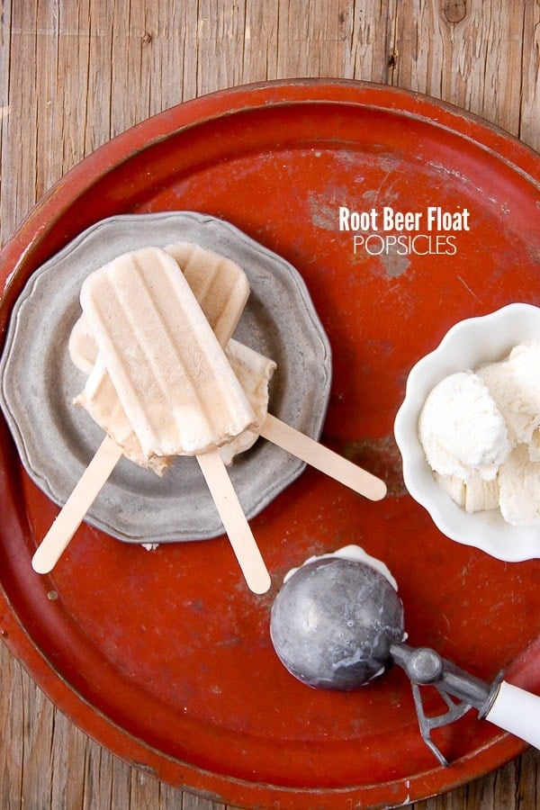 Creamy Root Beer Float Popsicles on pewter plate and distressed red metal tray 