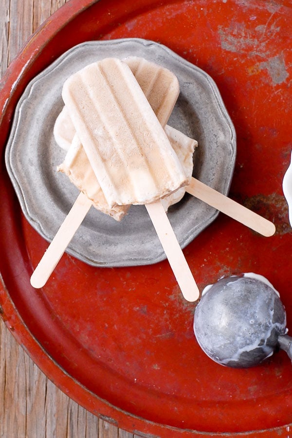 Stacked Root Beer Float Popsicles on a pewter plate 