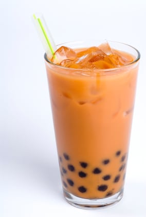 Glass of black tea with cream and tapioca