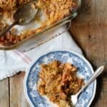Rhubarb Crisp on a plate with baking dish behind