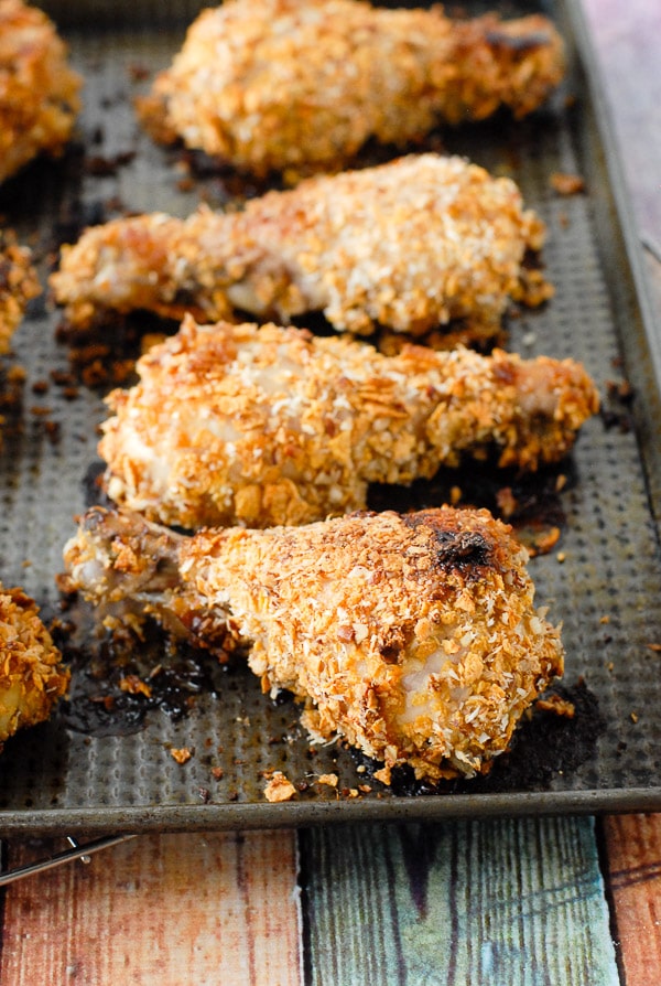 Cornflake-Coconut Crusted Baked Chicken on a baking sheet
