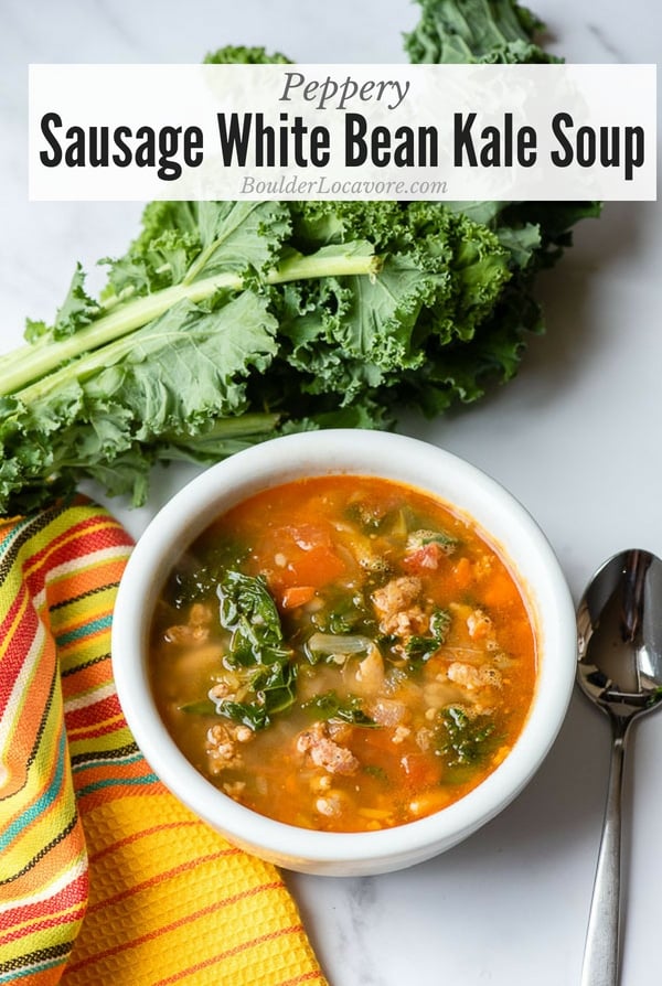 Peppery Sausage White Bean Kale Soup is an easy recipe with wholesome ingredients. Ready in under an hour, this spicy soup will be your new favorite comfort food. #soup #kale #curlykale #sausage #whitebeans #cannellini #easyrecipe #comfortfood #tips #glutenfree
