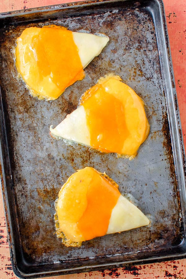 Three candy corn chicken quesadillas on baking sheet