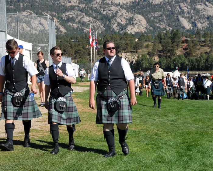 A group of men in matching kilts walking