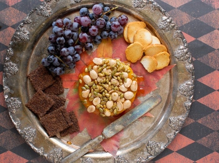 Baked Brie, Maple-Pumpkin Butter, Honey, Marcona Almonds, Pepitas on silver trsy