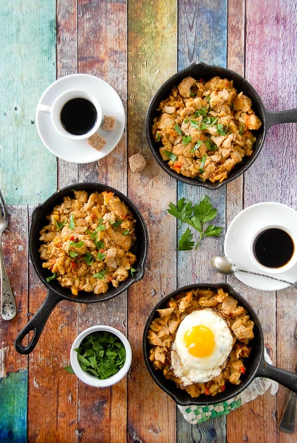 three mini skillets of holiday turkey hash with fried egg