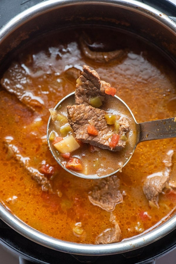steak soup in ladle